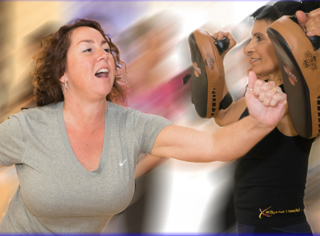 woman striking mitts in self-defense course