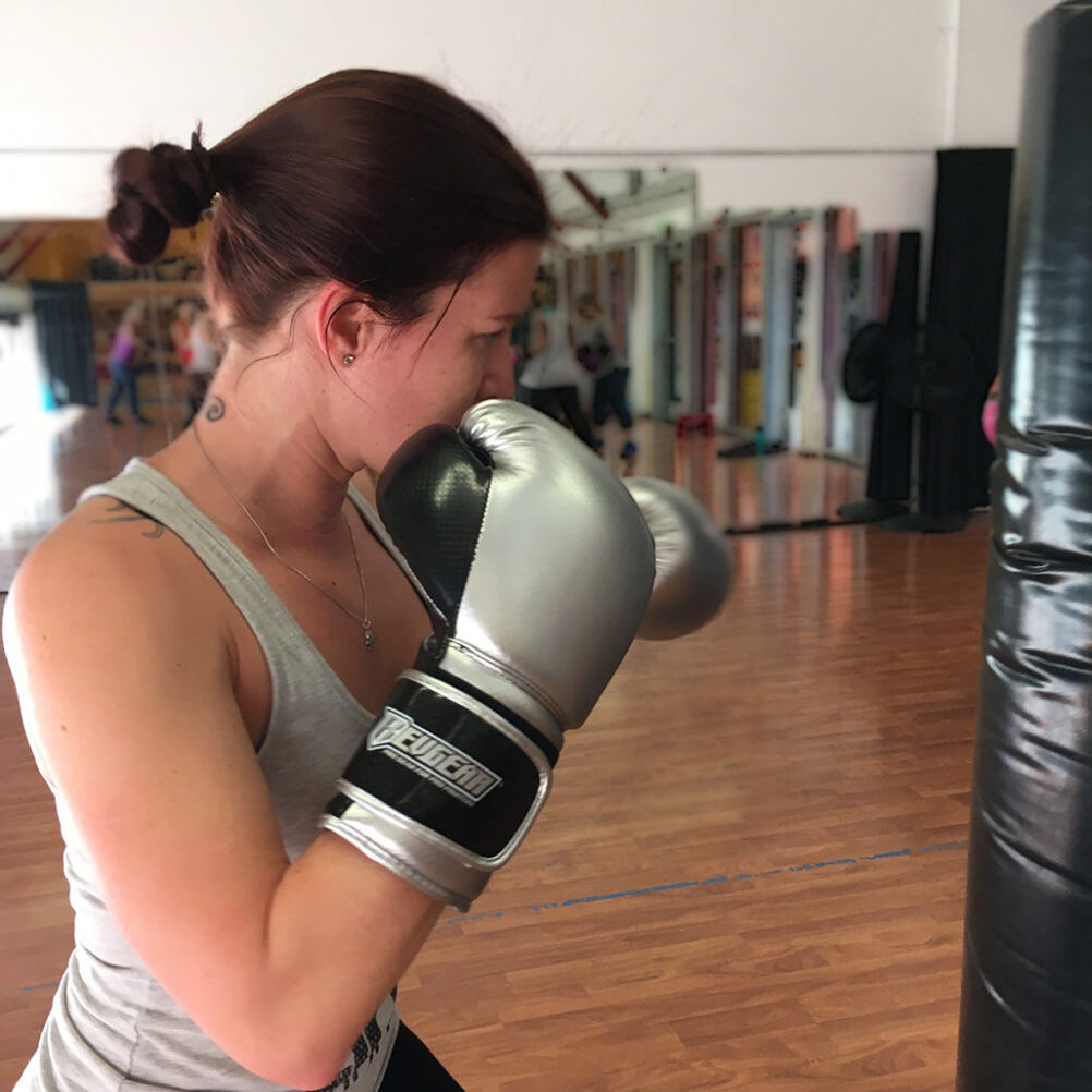 woman with gray gloves guard up